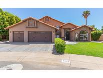 Two-story home with three-car garage and landscaping at 6325 E Monte Cristo Ave, Scottsdale, AZ 85254