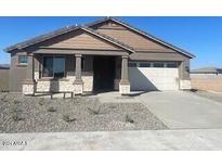 Single-story house with light brown exterior and two-car garage at 19026 W Stella Ave, Waddell, AZ 85355