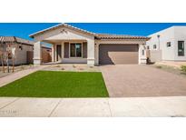 Modern curb appeal with artificial turf and brick driveway at 7380 W Bent Tree Dr, Peoria, AZ 85383