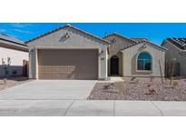 Single-story home with a two-car garage and desert landscaping at 2869 N Coronado Dr, Florence, AZ 85132