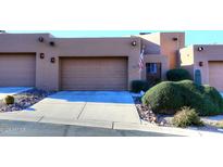 Tan stucco exterior with two-car garage and nicely landscaped front yard at 17025 E La Montana Dr # 107, Fountain Hills, AZ 85268