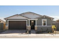 Single-story home with gray exterior, brown garage door, and stone accents at 4657 N 177Th Ln, Goodyear, AZ 85395