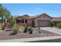 Single story home with landscaped front yard and garage at 41333 N Belfair Way, Anthem, AZ 85086