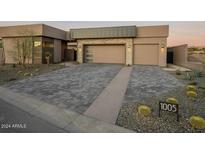 Modern home with stone and stucco exterior, paver driveway, and desert landscaping at 37200 N Cave Creek Rd # 1005, Scottsdale, AZ 85262