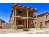 Two story home with balcony and desert landscaping at 853 E Agua Fria Ln, Avondale, AZ 85323