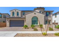 Two-story house with a large garage and landscaping at 14044 W Bronco Trl, Surprise, AZ 85374