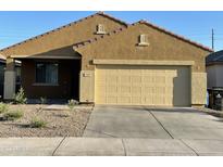 Tan one-story house with two-car garage and small front yard at 7329 W Preston Ln, Phoenix, AZ 85043