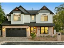 Two-story home with brick accents and a dark-colored garage door at 1331 W State Ave, Phoenix, AZ 85021