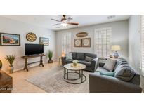 Living room with grey sectional sofa and a coffee table at 28959 N 124Th Ave, Peoria, AZ 85383