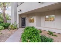 Condo building exterior with landscaping and walkway at 7710 E Gainey Ranch Rd # 133, Scottsdale, AZ 85258