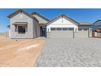 Two-story home with a three-car garage and stone accents at 1606 E Minton St, Mesa, AZ 85203