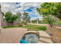 Landscaped backyard with patio and spa, overlooking a golf course at 2242 W Myrtle Dr, Chandler, AZ 85248