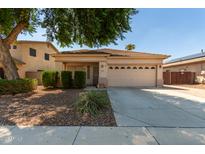 Single-story house with tan exterior and two-car garage at 14623 W Hearn Rd, Surprise, AZ 85379