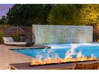 Luxury pool with fire pit, water feature, and comfortable seating at 12651 S 71St St, Tempe, AZ 85287