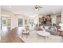 Open floor plan living area with hardwood floors and a cozy seating arrangement at 3518 N Shadow Trl, Mesa, AZ 85207