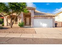 Single-story house with a two-car garage and desert landscaping at 902 E Goldenrod St, Phoenix, AZ 85048