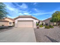 Single story home with two car garage and desert landscaping at 3128 E Millbrae Ln, Gilbert, AZ 85234