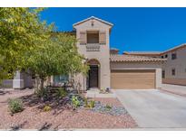 Two-story home with welcoming front porch and landscaping at 14760 W Riviera Dr, Surprise, AZ 85379
