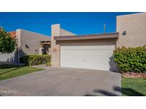 Front view of home with attached garage and landscaping at 3345 E University Dr # 72, Mesa, AZ 85213