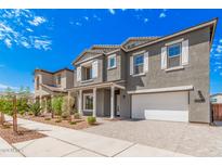 Two story home with gray siding, white trim, and landscaping at 20580 S 226Th St, Queen Creek, AZ 85142