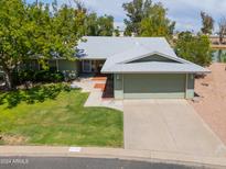 Front view of a single-story home with a two-car garage at 4906 E Lake Point Cir, Phoenix, AZ 85044
