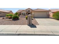 Attractive single-story home with desert landscaping and a two-car garage at 16121 W Silver Falls Dr, Surprise, AZ 85374