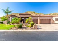 Beautiful home with stone accents and a three-car garage at 9845 E Inglewood St, Mesa, AZ 85207