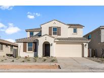 Two story home with beige exterior, brown accents, and a two car garage at 9951 S Centennial Rd, Apache Junction, AZ 85120