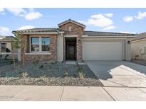 Single story home with brick facade and two car garage at 1521 W Saddle Run, Apache Junction, AZ 85120