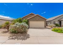 House exterior featuring a two-car garage and well-maintained landscaping at 3051 W Melinda Ln, Phoenix, AZ 85027