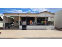 Mobile home exterior with covered deck and seating area at 17200 W Bell Rd # 569, Surprise, AZ 85374