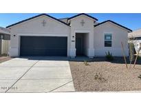 New construction home with a two-car garage and desert landscaping at 1252 S Mullberry St, Florence, AZ 85132