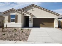 Charming single-story home with a two-car garage and well-manicured landscaping at 1690 N Camden Dr, Florence, AZ 85132