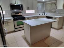 Modern kitchen with island and stainless steel appliances at 427 E Mayfield Dr, San Tan Valley, AZ 85143