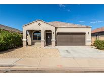 Single-story home with a two-car garage at 16922 N Verde Pl, Maricopa, AZ 85138