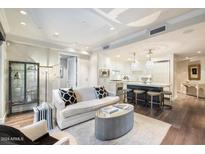 Open living room and kitchen with modern design and hardwood floors at 7175 E Camelback Rd # 107, Scottsdale, AZ 85251