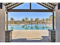 Community pool with lounge chairs and palm trees at 5837 N 89Th Dr, Glendale, AZ 85305