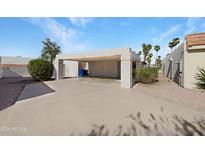 Home exterior with carport and desert landscaping at 2711 N Olympic Cir, Mesa, AZ 85215