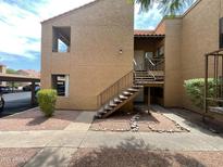 Tan two story building with stairs and landscaping at 8787 E Mountain View Rd # 1123, Scottsdale, AZ 85258