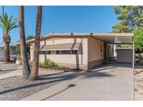 Front view of a manufactured home with carport, landscaping, and storage shed at 2650 W Union Hills Dr # 236, Phoenix, AZ 85027
