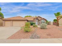 Single-story home with two-car garage, desert landscaping, and a large front yard at 3218 N Ravine --, Mesa, AZ 85215