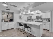 Modern kitchen with white cabinets, quartz countertops, and stainless steel appliances at 7777 E Main St # 161, Scottsdale, AZ 85251