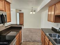 Kitchen with granite countertops and view to dining area at 5995 N 78Th St # 2067, Scottsdale, AZ 85250