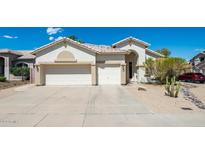 Two-car garage, desert landscaping, and a welcoming front porch at 3408 W Sands Dr, Phoenix, AZ 85027