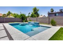 Inviting swimming pool with waterfall feature and spacious patio area at 2616 S Extension Rd, Mesa, AZ 85210