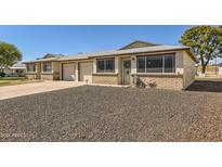 Front view of charming house with double garage and gravel landscaping at 10418 N 97Th Dr # B, Peoria, AZ 85345