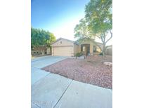 House exterior showcasing a two-car garage and well-manicured lawn at 2932 N 115Th Ln, Avondale, AZ 85392