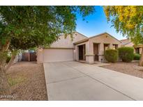 House exterior featuring a two-car garage and a paved driveway at 42356 W Balsa Dr, Maricopa, AZ 85138