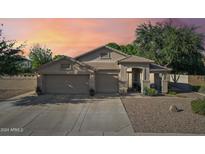 Exterior view of a two-story home with a three-car garage and landscaped yard at 1176 E Erie St, Gilbert, AZ 85295