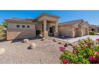 Beautiful stucco home with a three-car garage and desert landscaping at 17724 W Ocotillo Ave, Goodyear, AZ 85338